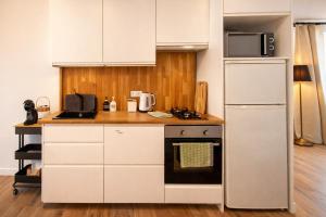 a kitchen with a white refrigerator and a microwave at Private Loft Sant Celoni, Montseny, Barcelona in Sant Celoni