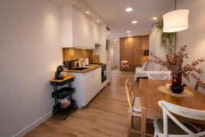 a kitchen and dining room with a table and a dining room at Private Loft Sant Celoni, Montseny, Barcelona in Sant Celoni