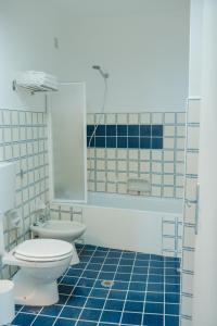 a blue tiled bathroom with a toilet and a sink at Casacasa Praiano in Praiano +22 photos