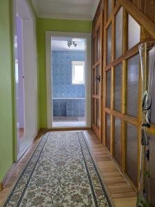 an empty hallway with a door and a window at Власний будинок in Rakhiv