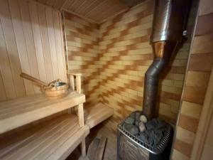 a inside of a sauna with a stove at Власний будинок in Rakhiv +3 photos