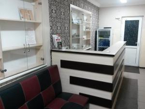 a bar in a restaurant with a red chair at Ulpan Mini Hotel in Astana