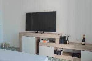 a flat screen tv sitting on top of a wooden entertainment center at Casacasa Praiano in Praiano