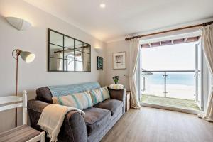 a living room with a couch and a large window at 1 Bed in Putsborough oc-b28792 in Croyde