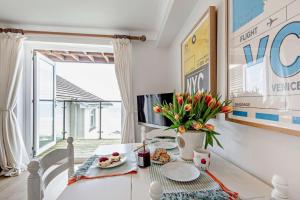 a living room with a table with a vase of flowers at 1 Bed in Putsborough oc-b28792 in Croyde