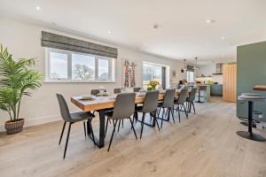a dining room with a long table and chairs at 6 Bed in Llanarthney oc-c28878 in Llanarthney