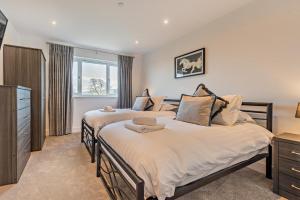 a bedroom with two beds and a dresser at 6 Bed in Llanarthney oc-c28878 in Llanarthney