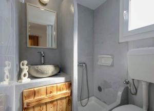 a bathroom with a sink and a toilet and a mirror at Naxos Diol in Naxos Chora +9 photos