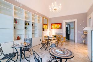 a room with tables and chairs and a living room at Piazzetta San Giovanni Specchia in Specchia +30 photos