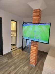 a flat screen tv on a brick pillar in a living room at Fani 2 in Lozenets
