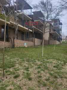 a building with a yard with trees in front of it at Fani 2 in Lozenets