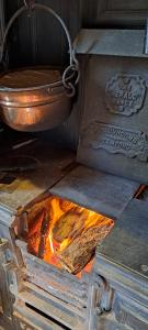 a stove with a pot and a fire in it at The Postgate Inn in Egton