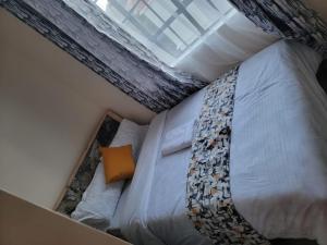 a bedroom with a bed with a tie on it at Serenity Homes in Gatunga