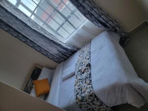 a bedroom with a bed with a tie on it at Serenity Homes in Gatunga