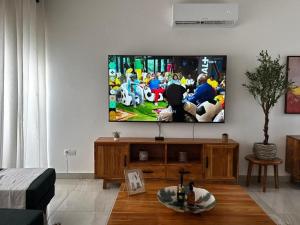 a living room with a flat screen tv on a wall at Villa EWA in Cotonou +13 photos