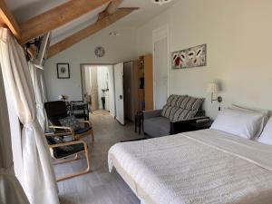 a bedroom with a bed and a living room at Le Poirier Perfect for 2 adults and 2 children Heated Pool and Games Room in Auverse +14 photos