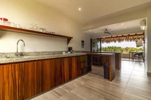 a kitchen with wooden cabinets and a counter top at El Secreto Residencial in Zihuatanejo