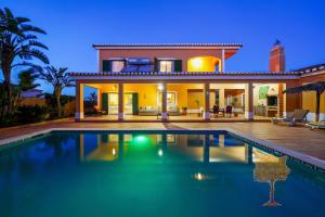 a house with a swimming pool in front of it at "Orange Tree Villa in Alvor - South - facing Family Villa with Private Poll" in Alvor