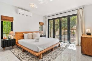 a bedroom with a bed and a large window at Alto Vista 63 in Noord +47 photos
