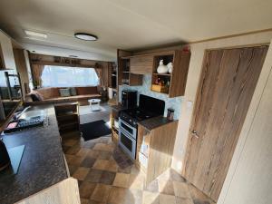 a kitchen and living room of a caravan at Caravan Turnberry 2 , Seton Sands, Wifi in Port Seton