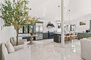 a kitchen with green cabinets and a tree in the middle at Alto Vista 63 in Noord