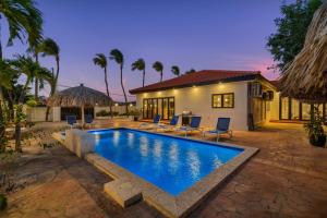 a swimming pool in front of a house at Alto Vista 63 in Noord