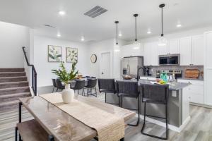 a kitchen and living room with a table and chairs at Sunny Springs, Hurricane, Ut in Hurricane