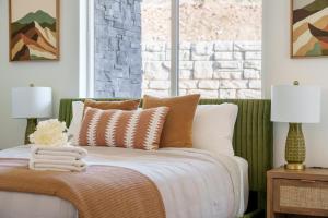 a bedroom with a bed with pillows and a window at Sunny Springs, Hurricane, Ut in Hurricane +32 photos