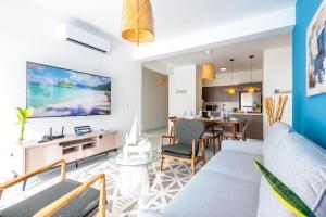 a living room with a couch and a table at Elegant 3BD Condo in Cocotal in Punta Cana
