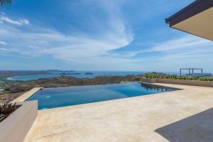a swimming pool with a view of the ocean at NEW! Oceanview, Infinity Pool, Spacious & Private Luxury Group Retreat in Potrero