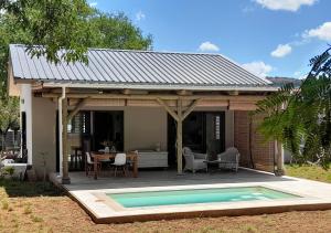 a house with a swimming pool in front of it at Chamallow Nature Lodge in Grande Case Noyale