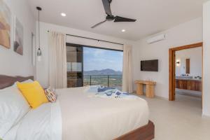 a bedroom with a large white bed and a large window at NEW! Oceanview, Infinity Pool, Spacious & Private Luxury Group Retreat in Potrero +73 photos