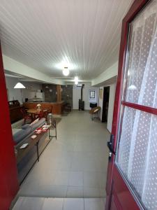 a living room with a red door and a room at Big Alface - Casa de Cima in Trinta