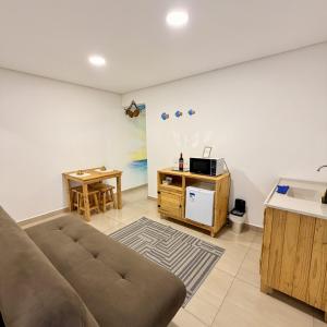 a living room with a couch and a table at Quarto Tema Praia - Top Country Ranch in Boituva