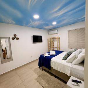 a bedroom with a bed with a blue ceiling at Quarto Tema Praia - Top Country Ranch in Boituva