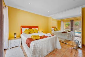 a bedroom with two beds and a large mirror at "Orange Tree Villa in Alvor - South - facing Family Villa with Private Poll" in Alvor +17 photos