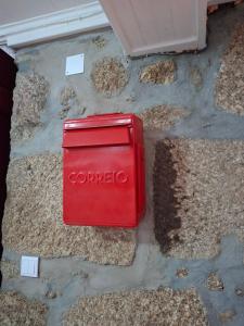 a red coke box sitting on the ground at Big Alface - Casa de Cima in Trinta +5 photos