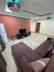 a living room with a couch and a flat screen tv at Ankyease Aclove in Kotrope