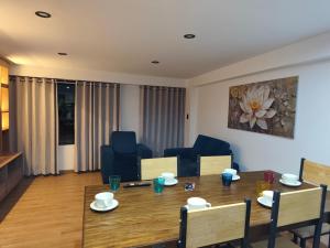 a living room with a table and a dining room at Casa Karmenka in Cusco