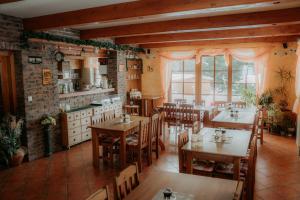 a restaurant with tables and chairs in a room at Chalupa Chudobka in Janske Lazne