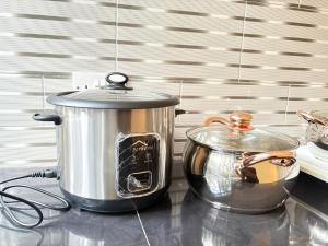 a slow cooker and a pot on a counter at Zanzibar Apartment 1 in Kibele