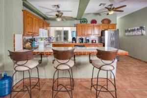 a kitchen with a counter with bar stools at Spacious Beachfront Condo Las Palmas II 11A in Puerto Peñasco