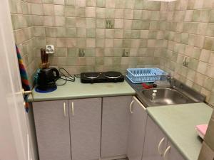 a small kitchen with a sink and a counter at Mossmarken Stay in Warsaw