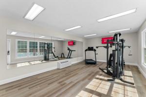 a gym with treadmills and exercise equipment in a room at Red Roof Inn & Suites Wilson in Wilson