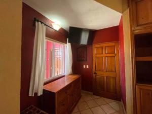 a kitchen with a wooden dresser and a window at Comfortable Beachfront Condo Las Palmas II 11 B in Puerto Peñasco