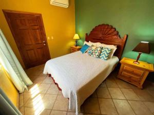 a bedroom with a bed and a green wall at Comfortable Beachfront Condo Las Palmas II 11 B in Puerto Peñasco