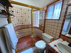 a bathroom with a shower with a toilet and a sink at Comfortable Beachfront Condo Las Palmas II 11 B in Puerto Peñasco +30 photos
