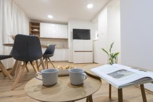 a living room with a table and two mugs on it at Apartman ''Kod bake'' Delnice biker-friendly in Delnice