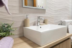 a bathroom with a white sink and a mirror at Apartman ''Kod bake'' Delnice biker-friendly in Delnice +27 photos