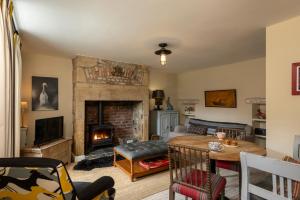 a living room with a fireplace and a table at Sandpiper Alnmouth in Alnmouth